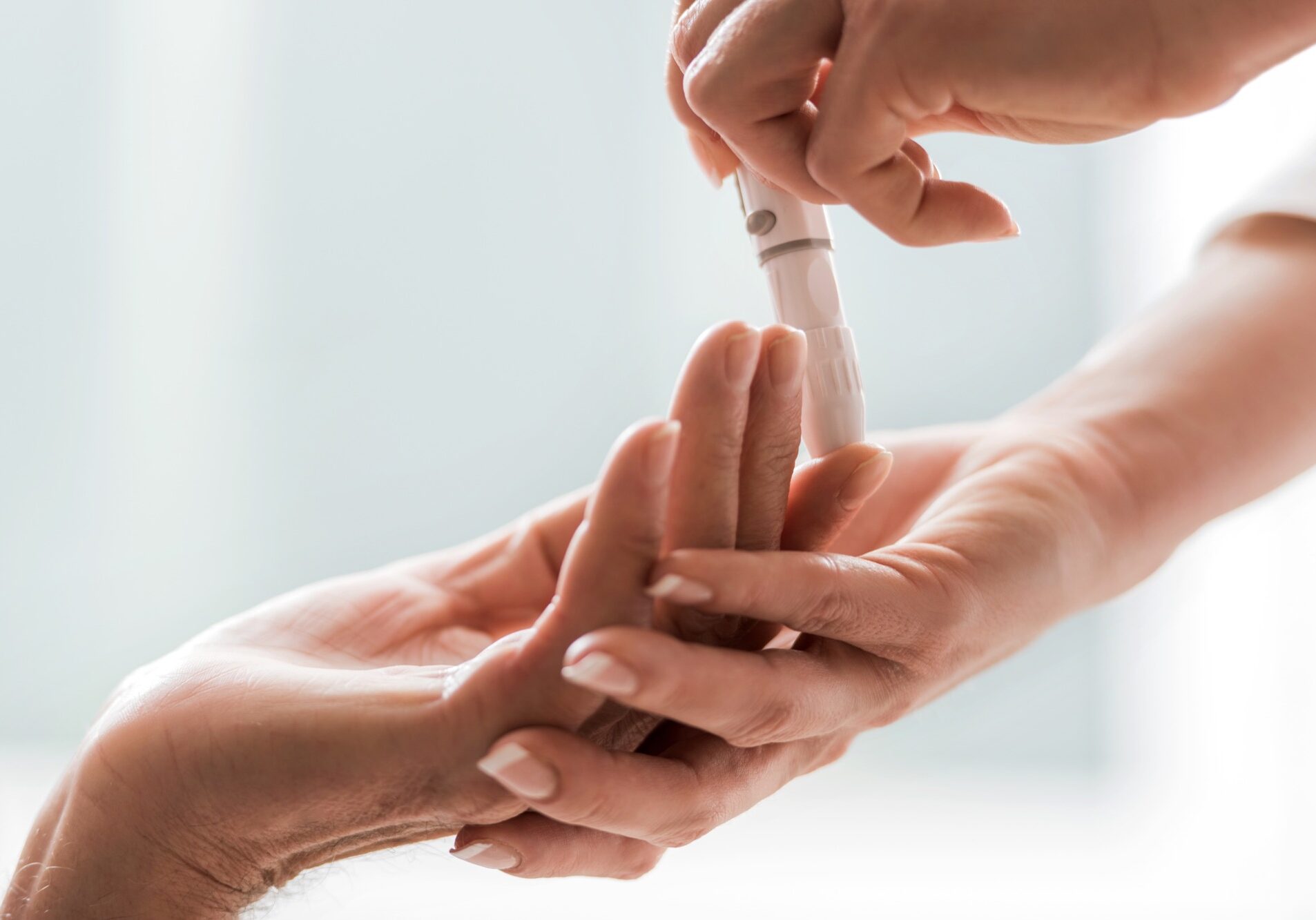 Close-up of taking blood sugar test from a finger.