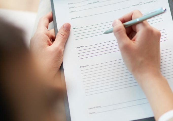 Female counselor writing down some information about her patient